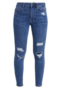 Jeans skinny blu con strappi consunti su cosce e ginocchia, dotati di tasche frontali e passanti per cintura.