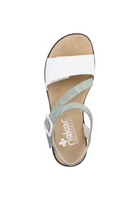 White synthetic sandal with a brown sole and light green adjustable strap. Cushioned footbed features a textured finish and logo.