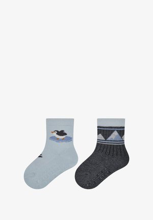 Two pairs of children's socks: one light blue with a penguin design, and one dark gray with a mountain pattern. Soft, knitted fabric.