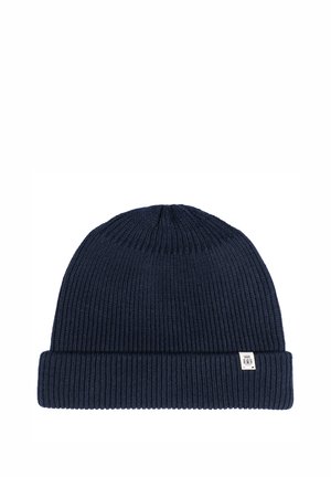 Navy blue knit beanie made from ribbed material, features a folded cuff and a small branded tag on the side.