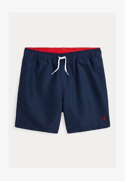Calções de banho azul-marinho feitos de material leve, com uma cintura elástica, forro interior vermelho, cordão branco e um pequeno logótipo bordado.