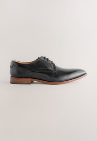 Black leather dress shoe with a pointed toe, subtle stitching details, and a low brown heel. Smooth texture and classic design elements.
