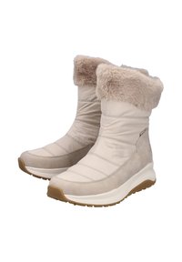Botas de invierno beige con borde de piel, parte superior acolchada, suela intermedia blanca con amortiguación y suela de goma marrón, diseñadas para el clima frío.