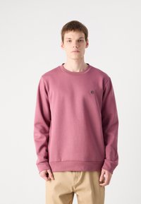 Felpa crewneck viola in cotone, con maniche lunghe e un piccolo emblema sul petto. Tessuto liscio e vestibilità comoda.