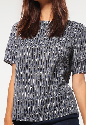 Short-sleeve top in navy with a white and blue abstract pattern. Features a round neckline and soft, textured fabric.