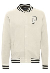 Light beige varsity jacket made of soft fabric, featuring ribbed black and white striped collar and cuffs, and a prominent embroidered 'P' on the chest.