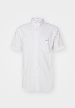 Short-sleeve white button-up shirt made of lightweight cotton, featuring a chest pocket and subtle logo on the pocket. Smooth texture.