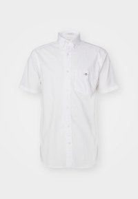 Short-sleeve white button-up shirt with breast pocket featuring small embroidered logo, and buttoned collar.