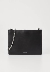 Black leather handbag with a rectangular shape, featuring a silver chain strap and a logo at the bottom. Smooth texture and minimalist design.