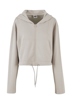 Haut en hoodie beige coupé, avec une fermeture éclair à l'avant, des manches longues, deux poches avant et un cordon de serrage au bas, fabriqué en tissu lisse.