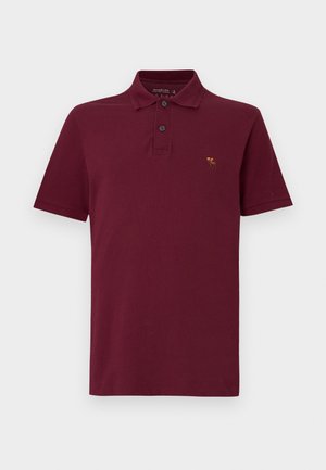 Polo bordeaux in cotone, con chiusura a due bottoni, maniche corte e piccolo logo ricamato sul petto.
