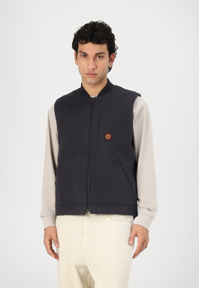 Navy zip-up vest with high collar, front pockets, and a small red logo. Sleeves are light gray, creating a two-tone contrast.