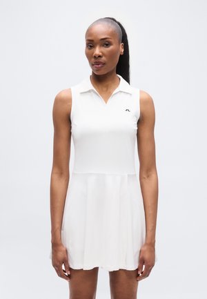 Biele šaty bez rukávov s golierovým výstrihom, priliehavým živôtikom a rozšírenou sukňou. Na ľavej strane na hrudi je logo. Hladká tkanina.