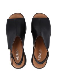Zwarte leren open-teensandalen met verstelbare enkelbandjes, bruine binnenzolen en een gladde textuur. Bevat een gevormde voetbed en een lichte hak.