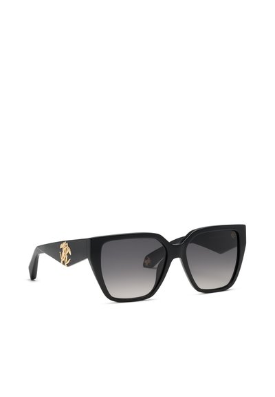 Lunettes de soleil noires oversize forme œil de chat avec verres gris dégradés et petit emblème doré sur la branche.