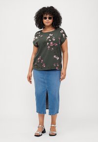 Olive green top with pink floral print, short sleeves. Blue denim midi skirt with front slit. Silver sandals with ankle straps.