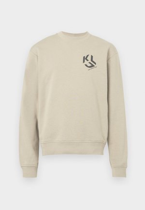 Beige mikina s dlouhými rukávy. Obsahuje kulatý výstřih a malý černý logotyp na hrudi. Měkký bavlněný materiál.