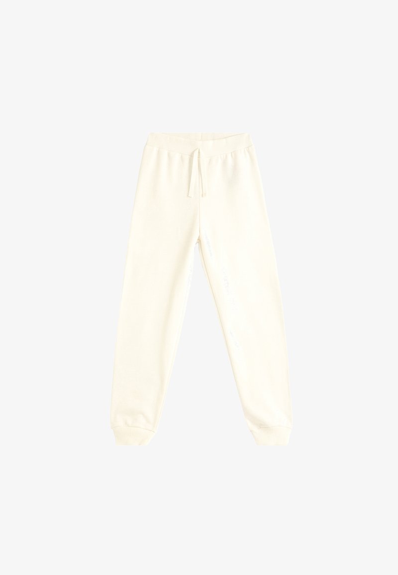 Pantalon de jogging crème clair avec une taille élastique, cordon de serrage ajustable et bas en côtes. Fabriqué dans un tissu doux et confortable.