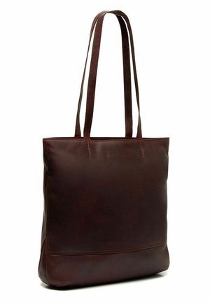 Sac fourre-tout en cuir marron avec de longues sangles, forme rectangulaire, texture lisse et un design minimaliste mettant en avant un logo discret à l'avant.
