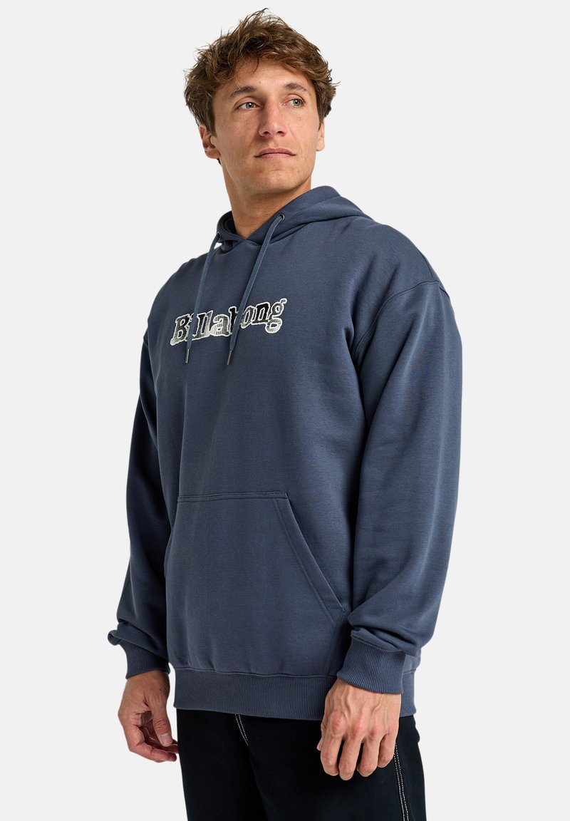 Blue hoodie made of soft fabric with a kangaroo pocket, drawstring, ribbed cuffs, and featuring a contrasting logo in the center.