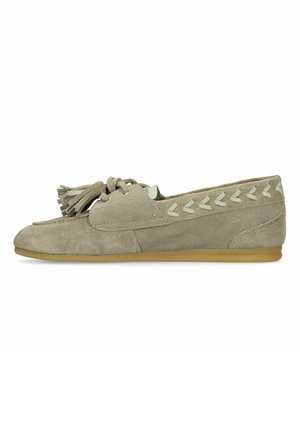 Light brown suede loafer with tassels on top, decorative white chevron stitching along sides, and flat rubber sole.