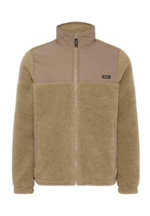 Tan fleecejack met ritssluiting aan de voorkant, hoge kraag en contrasterende gladde stofpanelen op de bovenborst en mouwen.