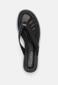 Black cushioned flip-flop sandal with white sole, FENTY logo on footbed, and Puma logo on strap, shown from above on white background.