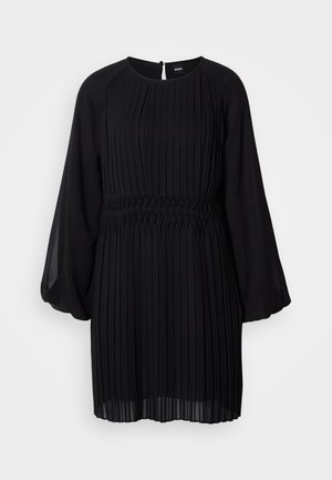 Black pleated dress with long, sheer sleeves and a fitted waist. Features a round neckline and a keyhole back closure. Crafted from lightweight fabric.