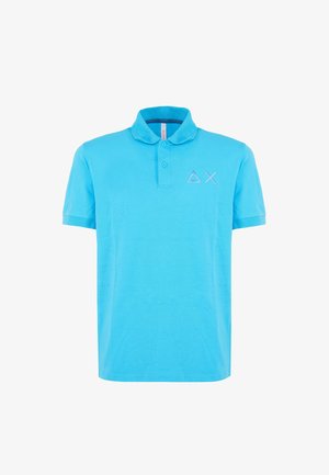 Light blue polo shirt made of cotton with short sleeves, a collar, and three buttons. Features embroidered geometric logo on chest.