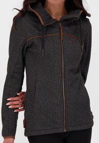 Šedá mikina na zip s texturovaným povrchem, hnědými akcenty podél zipu a kapuce a s nastavitelnými stahovacími šňůrkami. Obsahuje logo na hrudi.
