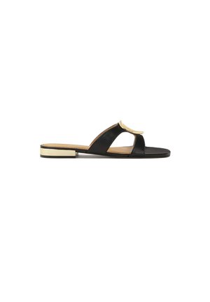 Black leather slide sandal featuring an open toe, curved straps, and a metallic accent. Flat sole with a contrasting gold band at the base.