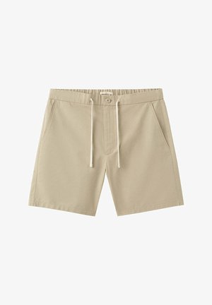 Shorts décontractés beiges avec taille élastique, fermeture par bouton, cordon de serrage et poches latérales, adaptés pour un usage quotidien.