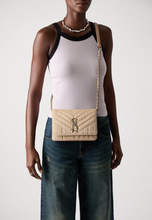 Quilted beige handbag with a gold chain strap and logo detail, displaying a rectangular shape and textured surface.