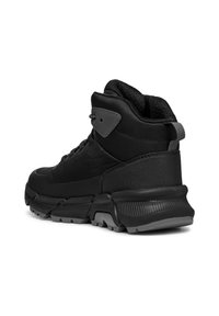 Black high-top sneaker with a textured mesh and synthetic material. Features a thick sole, padded collar, and gray accents.