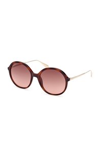 Occhiali da sole rotondi con montatura in tartaruga, lenti rosa sfumate e dettagli in metallo dorato. La montatura ha una finitura liscia e una forma ampia.