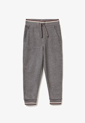 Pantalones de chándal grises hechos de un tejido suave, con piernas ajustadas, bolsillos laterales y una cintura de canalé con rayas rojas y crema.