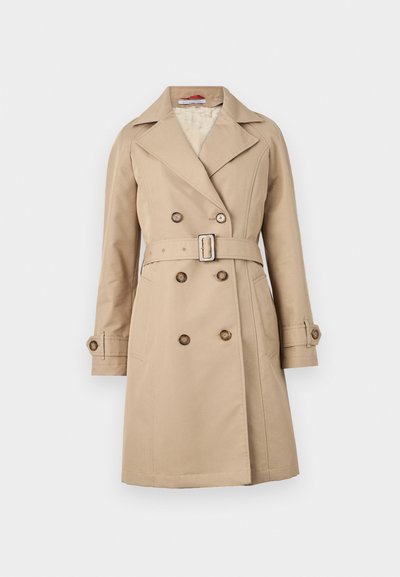 Beige trench coat with a double-breasted design, broad lapels, belted waist, and buttoned cuffs; made from a smooth fabric.