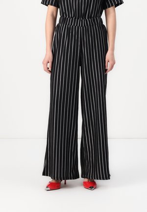 Black and white striped wide-leg pants with a high waist and elastic band, featuring a textured fabric and relaxed fit.