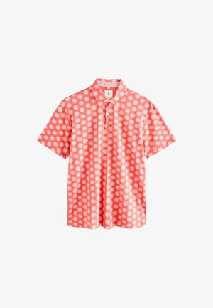 Rövid ujjú pólóing sima pamutból, korall színű háttérrel, fehér napkitörés mintával, klasszikus gallérral és gombos zárással.