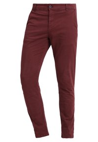 Pantaloni aderenti in cotone bordeaux con chiusura a bottone, caratterizzati da una texture liscia e un design minimale. Ideali per un look casual.