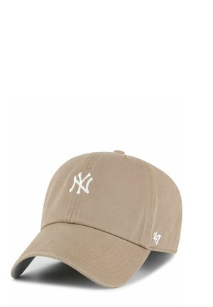 Beige baseball cap with white New York Yankees logo on front and small '47' logo on side, curved brim, fabric material.