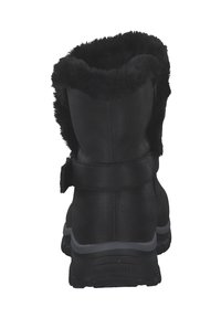 Bottes noires avec un revers en fausse fourrure. Dotées d'un matériau synthétique lisse, d'une sangle au dos et d'une semelle en caoutchouc texturé pour une bonne adhérence.