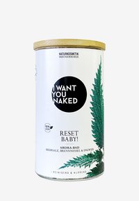 Contenitore rotondo con coperchio in bambù. L'etichetta bianca presenta un design con foglia verde e un testo nero in grassetto: "TI VOGLIO NUDO" e "RIPRISTINA BABY!"