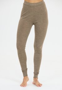 Ljusbruna leggings gjorda av mjukt, stretchigt material, med en sömlös hög midja och åtsittande ankle cuffs.
