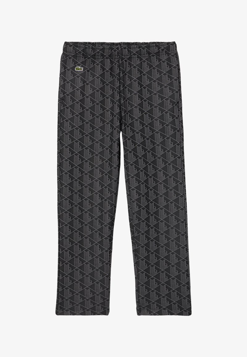 Pantalons en polaire noire avec un motif géométrique gris, une taille élastique et un petit logo sur le devant gauche.