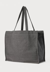 Grå stoff tote bag med to lange håndtak, rektangulær form og sømmer. Glatt tekstur uten synlige mønstre eller maskinvare.