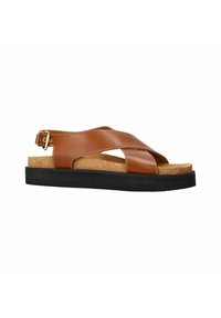 Bruine leren sandalen met een kruisbandontwerp, kurken inlegzool en een zwarte rubberen zool. Gouden gespaccent op de enkelband.