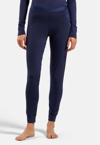 Navy athletic leggings with a fitted design, soft fabric, and elastic waistband. Cuffs at the ankles provide structured fit.