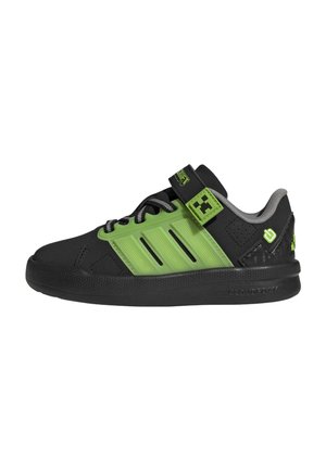 Black and green low-top sneaker with three black lace eyelets, Velcro strap, and cushioned sole for casual wear.