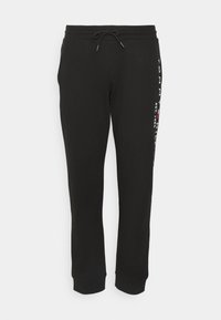 Zwarte katoenen sweatpants met een trekkoord in de taille, taps toelopende pijpen en gedrukte logo-accenten langs de zijkant. Zacht, glad textuur.